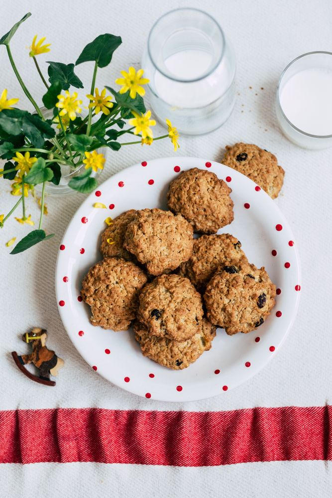 Cookies and milk near flowers
