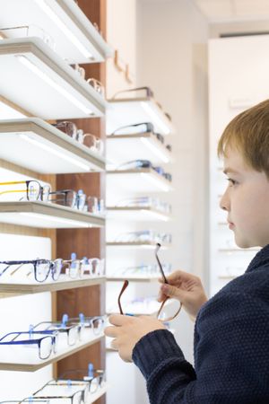Young boy trying on glasses