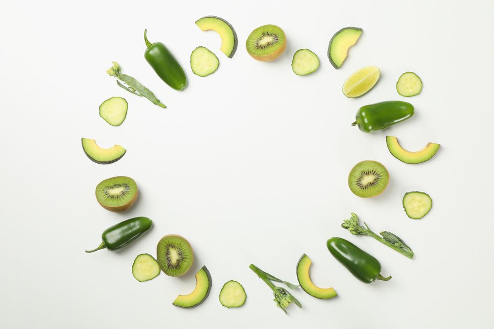 Green vegetables and fruits on blank background