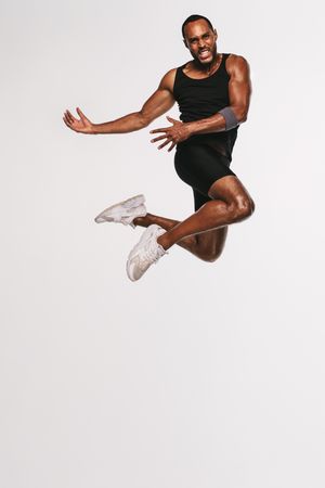 Action shot of athletic male jumping in mid air