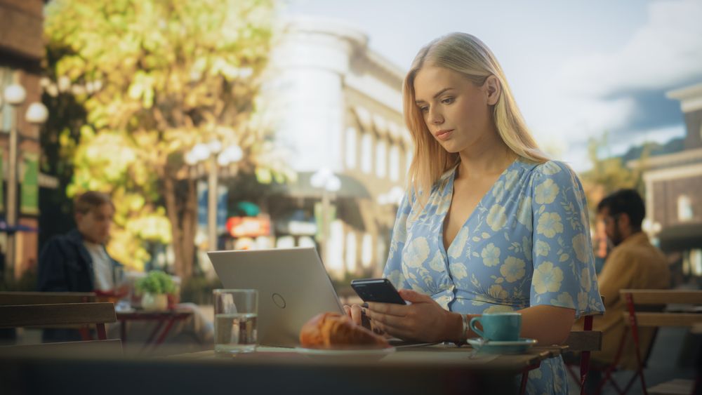 Female Manager Working Remotely on a City Terrace in a Lovely Restaurant.
