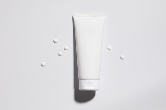 Mockup of plastic tube of cream with dots of product