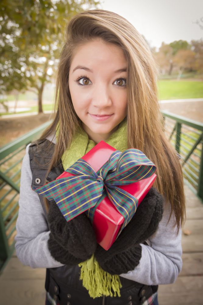 Female with Wrapped Gift with Bow Outside