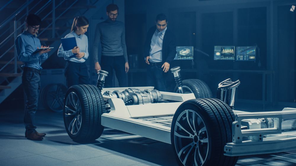 Team of Automotive Engineers Discussing and Designing Electric Car Platform Chassis Prototype