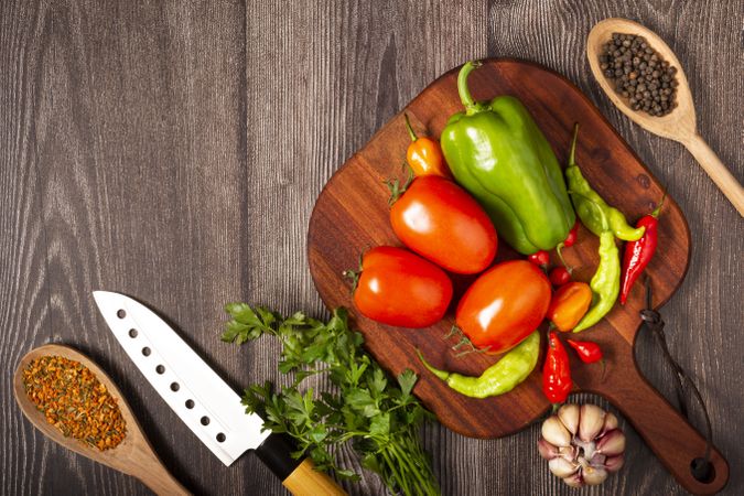 Ingredients for cooking with tomatoes, various peppers, garlic and green peppers.