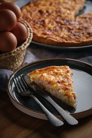 Piece of quiche served on plate