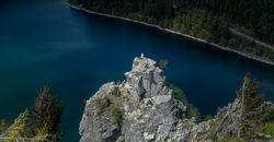 Looking down at religious statue of Virgin Mary overlooking a lake