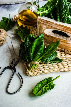 Spinach leaves with oil on rattan placemat