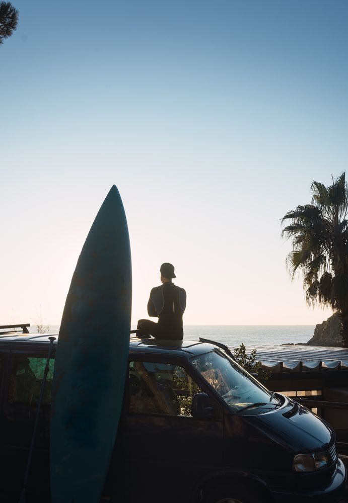Man enjoying the sunrise in his camped van
