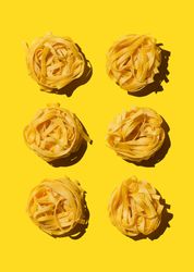 Bird's nest pasta organized over yellow background