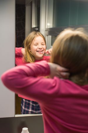 Cute girl brushing her teeth