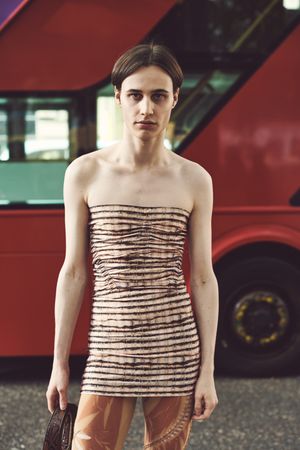 London, England, United Kingdom - September 18 2021: Person in sleeveless shirt in front of a bus