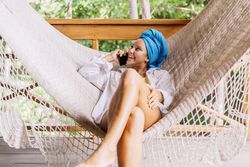 Woman in turban resting in hammock