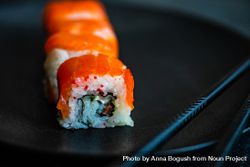 Salmon sushi rolls served on stone slate with chopsticks 0gXgeN