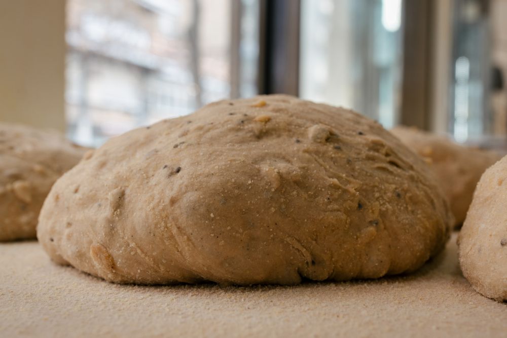 Loaf-shaped bread dough on the table