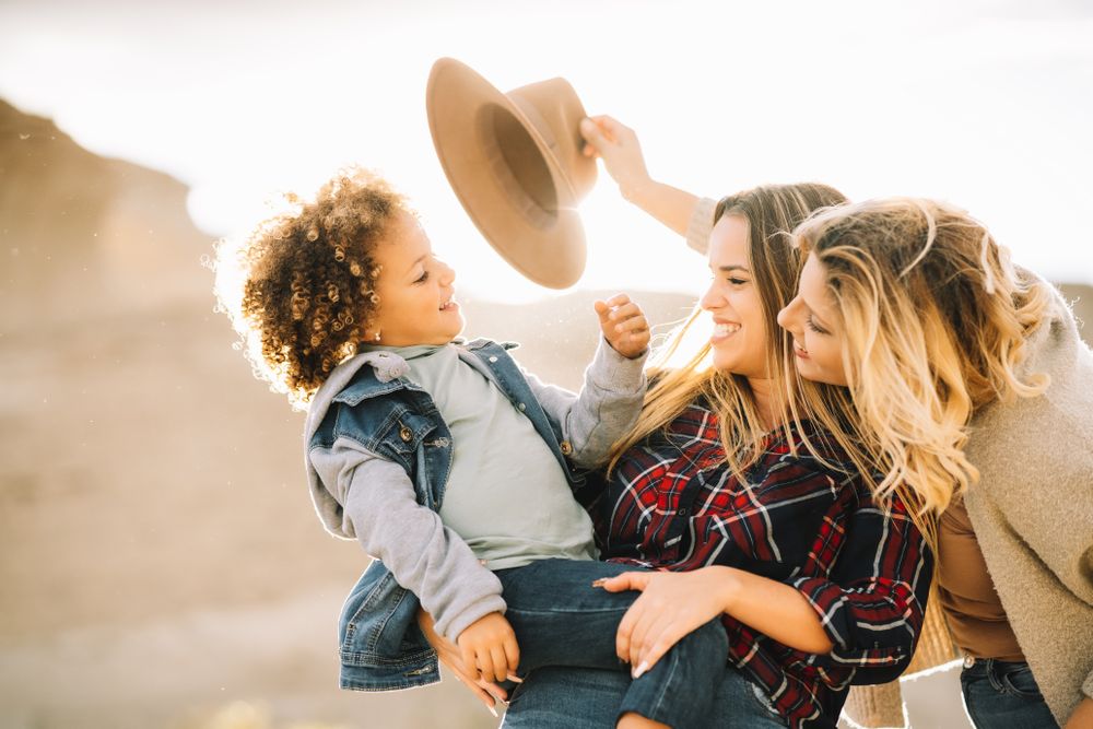 Smiling blond women walking with curly child