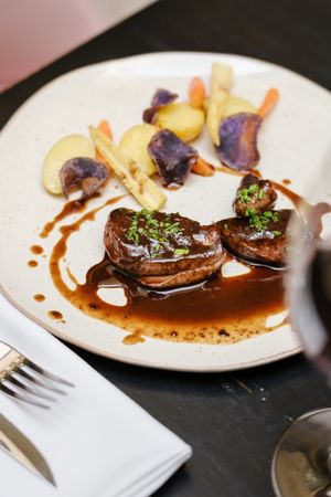 Delicious dinner with beef steaks and red wine in restaurant