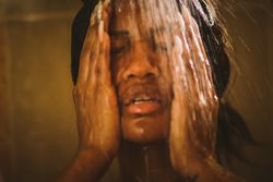 Cheerful female taking shower