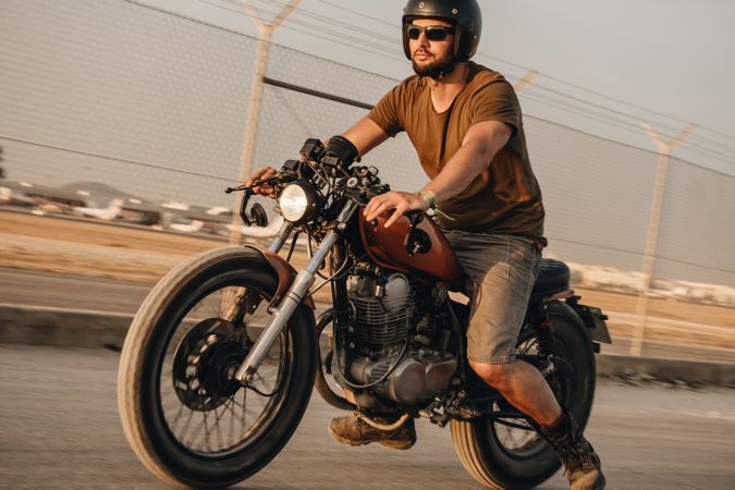 Strong man driving motorcycle