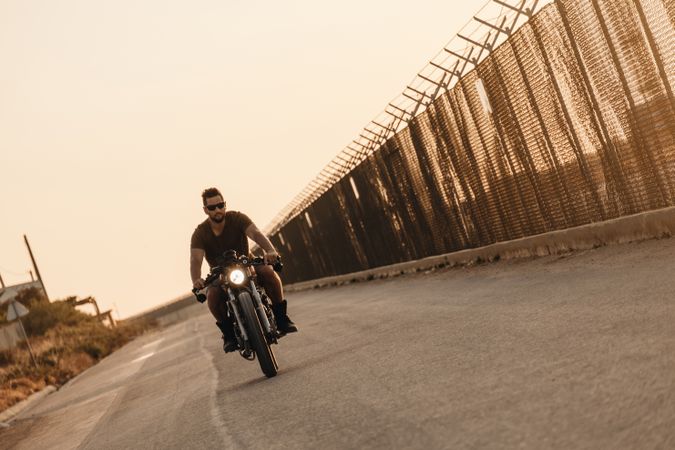 Strong man driving motorcycle