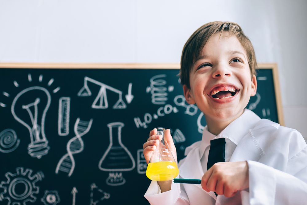 Happy kig laughing and showing liquid in flask