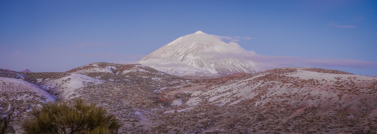 Clouds near snowy mountain