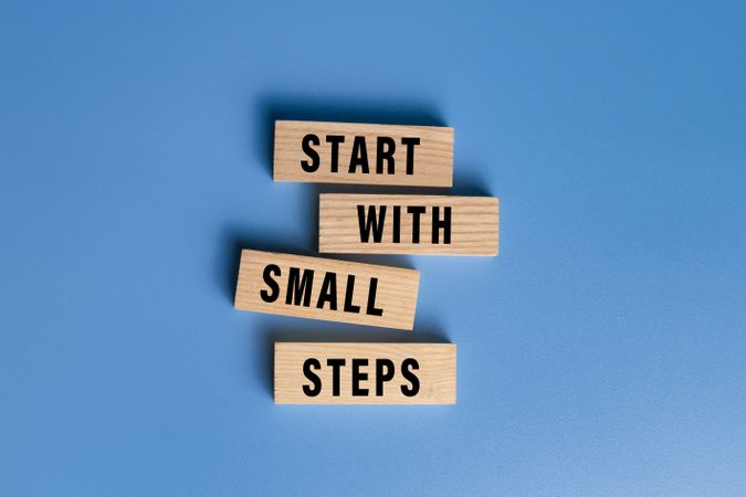 start with small steps words text on wooden blocks isolated on blue background