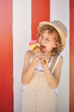 Adorable boy eating delicious ice cream