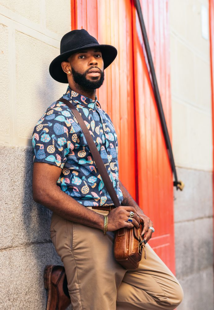 Portrait of a stylish Black man in hat and alternative outfit