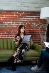Transgender woman discussing notes with a colleague