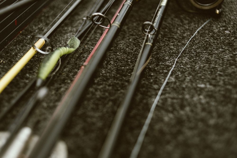 Fishing rods on pebbles on cloudy day