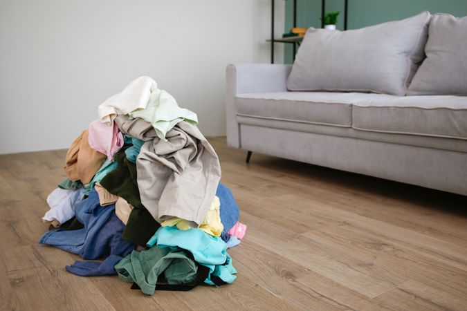 Pile of carelessly scattered clothes on floor.