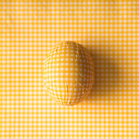 Yellow checkered Easter egg with matching background