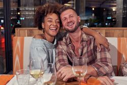Happy multiethnic couple in restaurant