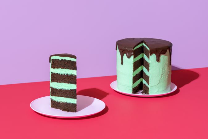 Chocolate layer cake with mint flavor buttercream, minimalist on a red table