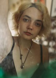Charming melancholy woman looking at camera