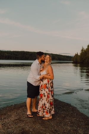 Loving couple standing ankle deep in water on beach