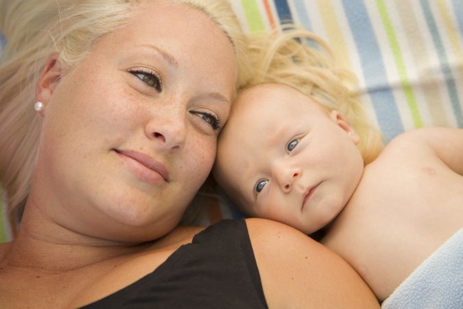Cute Baby Boy Laying Next to His Mommy on Blanket