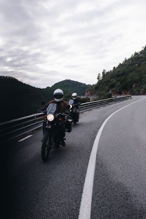 Two motorcycle drivers traveling on highway