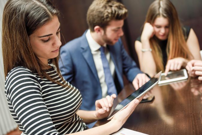 Colleagues using digital tablet during a meeting