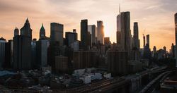 Lower Manhattan Bird's Eye Tour of New York City, USA. Aerial Urban Scenery From a Helicopter. Big Apple Office Buildings and Skyscrapers on a Sunny Summer Evening with Blue Sky and Light Clouds