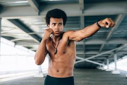 Black male athlete throwing a punch during training
