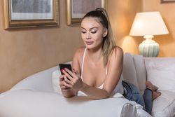 Woman using smartphone on soft sofa