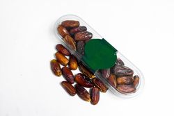 Dates fruit in plastic package with blank green label for product mockup design