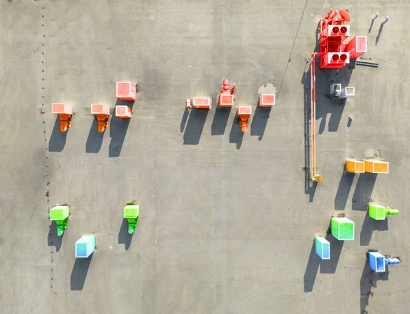 Aerial shot of multicolored gradient blocks and buildings in industrial lot