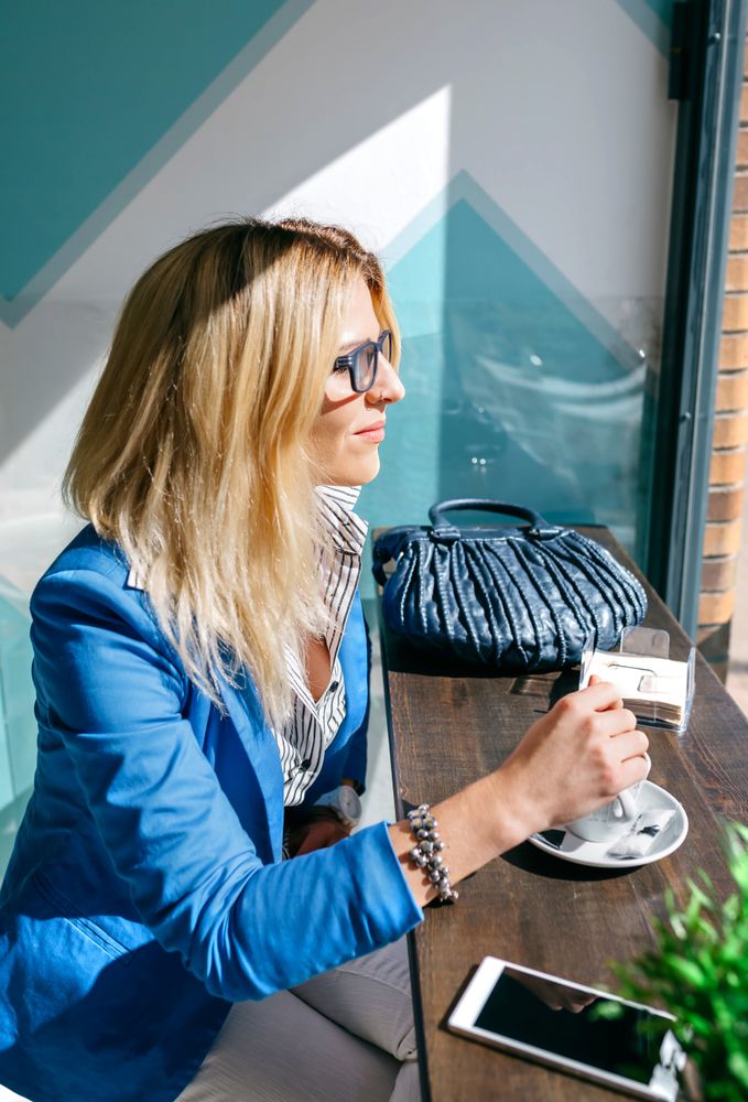 Young woman stiring coffee
