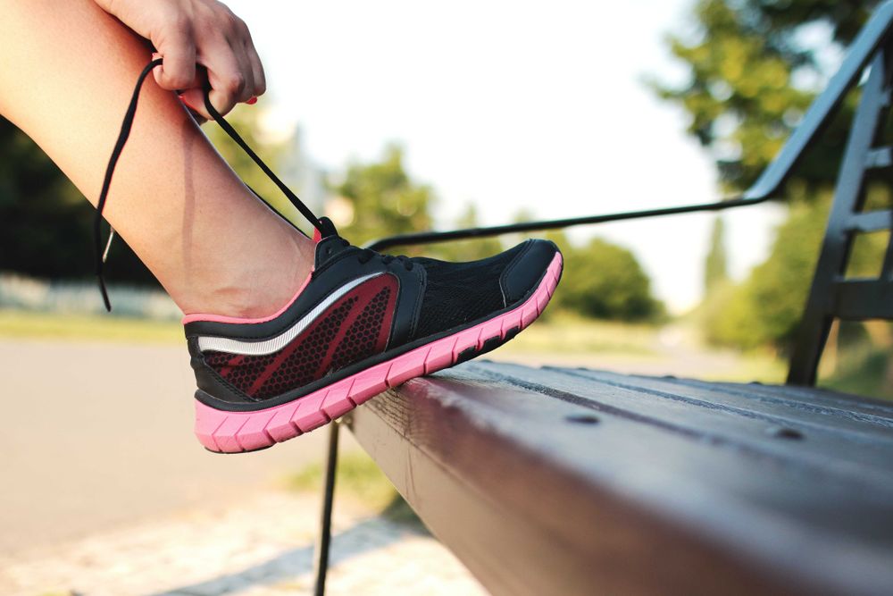 Person tying shoelace