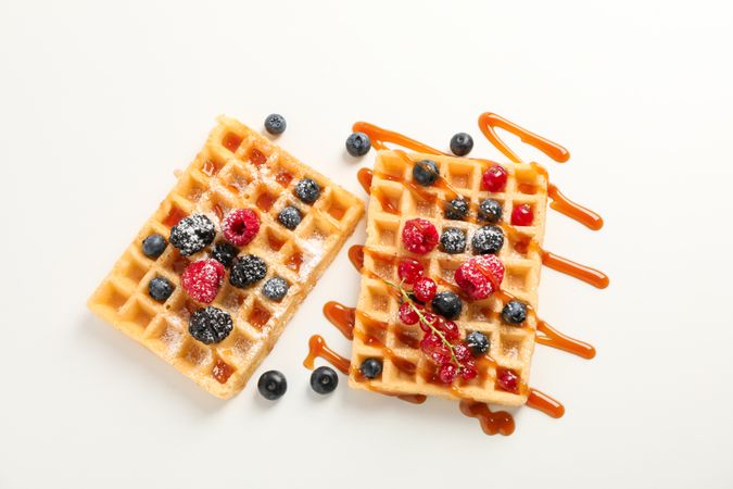 Waffles under caramel topping on blank background