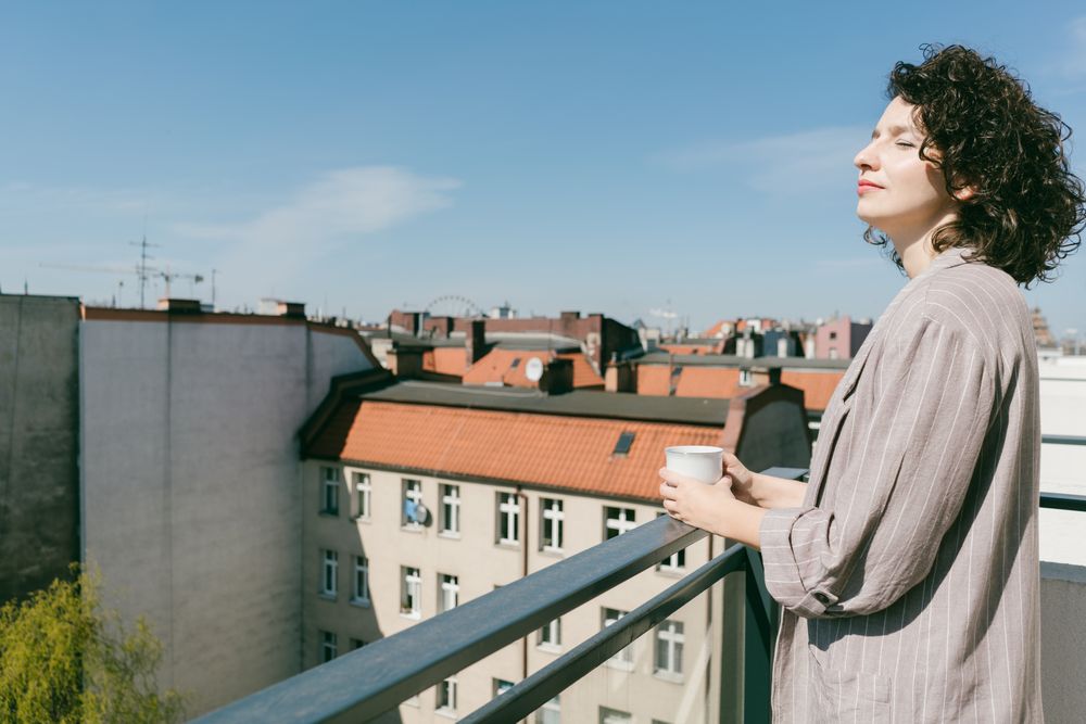 Elegant woman enjoying sun at terrace