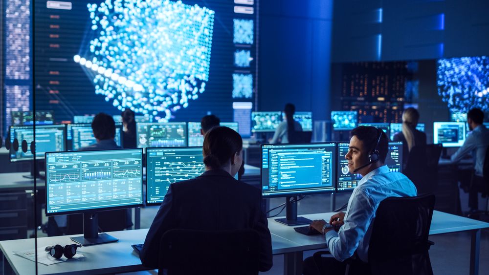 Professionals in a High-tech Control Room Analyze Complex Data on Multiple Screens, Enhancing Cybersecurity Strategies With Teamwork and Innovation. the Environment Fosters Precision and Strategic Insights.